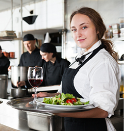 Waitress carrying food in kitchen