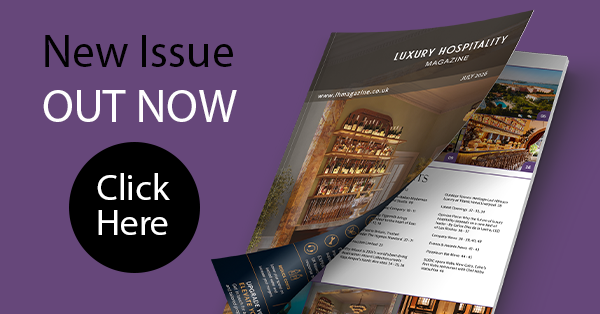 Advertisement for Luxury Hospitality Magazine with an open magazine showing elegant interiors. Text reads: 'New Issue Out Now. Click Here.' The color scheme is sophisticated with purple and black accents.
