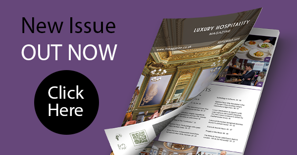 Advertisement for Luxury Hospitality Magazine with an open magazine showing elegant interiors. Text reads: 'New Issue Out Now. Click Here.' The color scheme is sophisticated with purple and black accents.